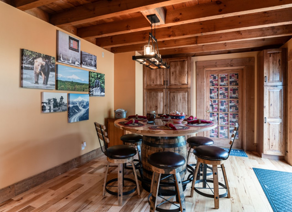Mountain style l-shaped medium tone wood floor kitchen photo in Boston with an undermount sink, raised-panel cabinets, medium tone wood cabinets, granite countertops, gray backsplash, stainless steel appliances, an island and black countertops