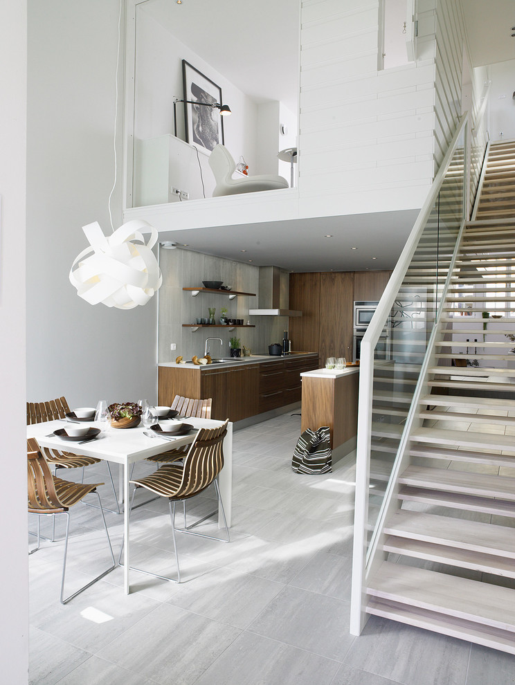Large scandinavian open plan dining in Stockholm with white walls, limestone floors and no fireplace.