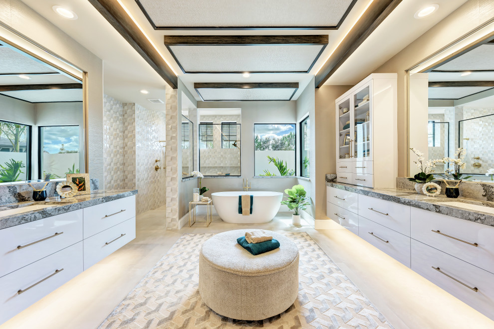 Idéer för funkis flerfärgat en-suite badrum, med släta luckor, vita skåp, ett fristående badkar, en öppen dusch, beige väggar, ett undermonterad handfat och marmorbänkskiva