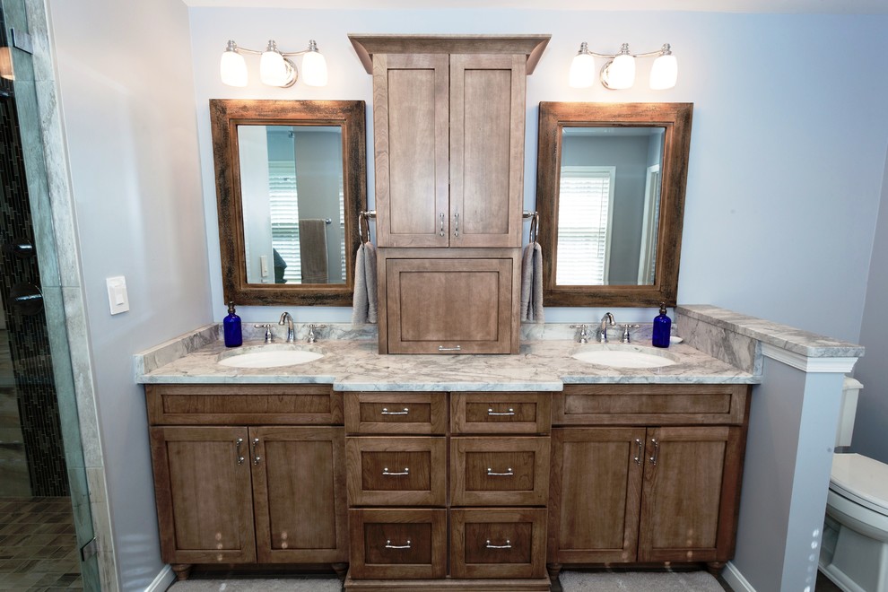 Mid-sized arts and crafts master bathroom in DC Metro with shaker cabinets, light wood cabinets, an alcove shower, a two-piece toilet, blue walls, ceramic floors, an undermount sink and marble benchtops.