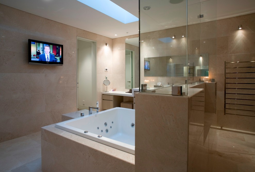 Inspiration for a large modern bathroom in Sydney with light wood cabinets, granite benchtops, a hot tub, a double shower, beige tile, porcelain tile, beige walls and travertine floors.