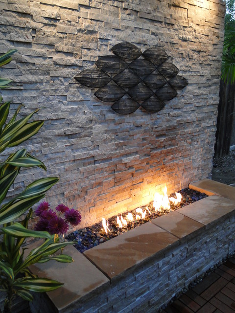 Tropical Hawaiian retreat with a light natural stone veneer fireplace.