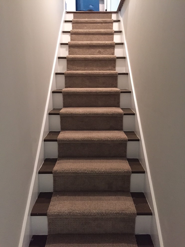 Mid-sized contemporary carpeted straight staircase in Atlanta with wood risers.