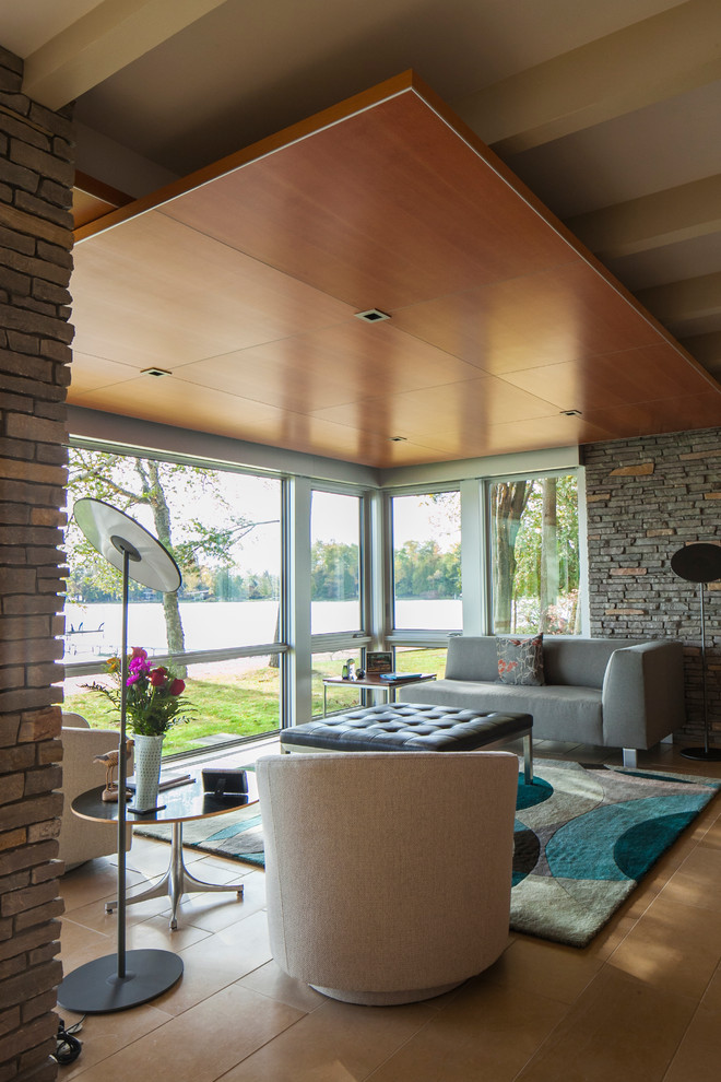 Inspiration for a mid-sized midcentury open concept living room in Other with a two-sided fireplace, a stone fireplace surround, no tv and limestone floors.