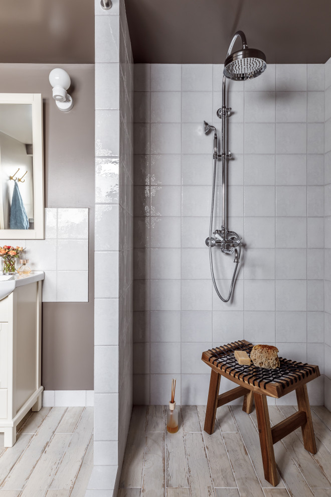 Inspiration for a mid-sized country 3/4 bathroom in Other with beige cabinets, an alcove shower, white tile, grey walls, an integrated sink, beige floor, an open shower and white benchtops.