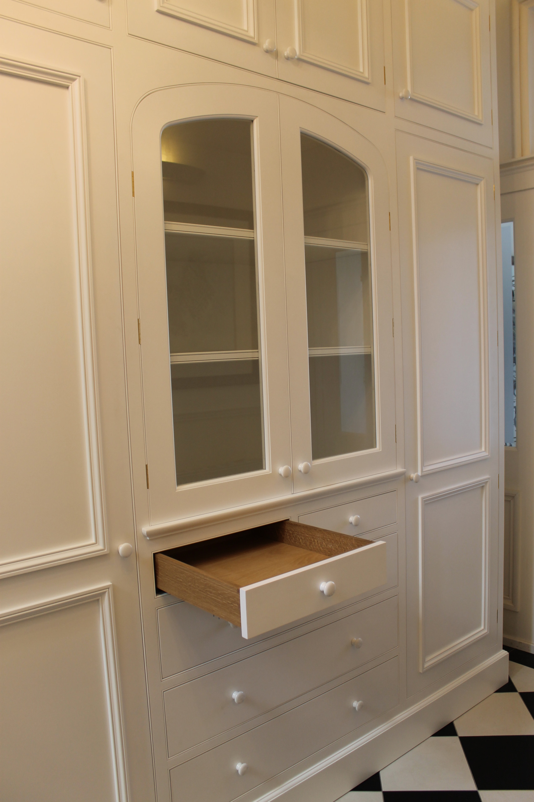 Hallway cabinet with three center arched glazed doors