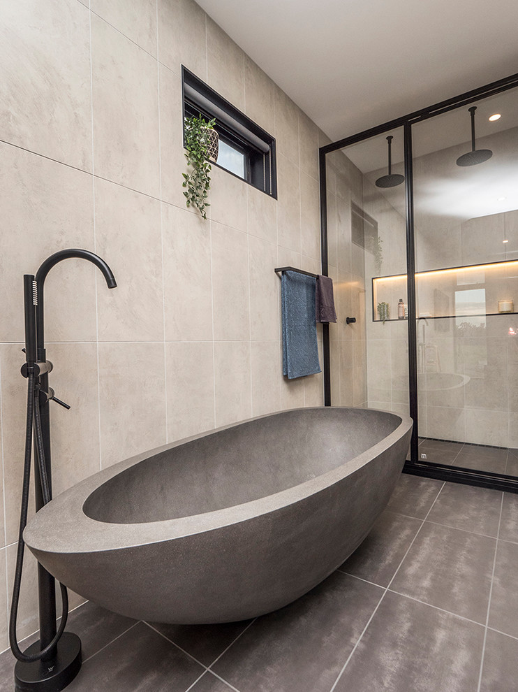 This is an example of a mid-sized contemporary master bathroom in Other with black cabinets, a freestanding tub, a double shower, gray tile, grey walls, ceramic floors, wood benchtops, grey floor and a hinged shower door.