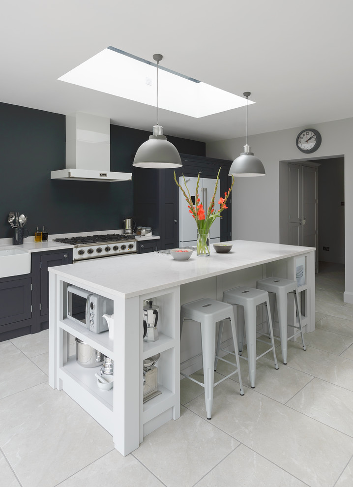 Inspiration for a small transitional single-wall eat-in kitchen in Gloucestershire with shaker cabinets, dark wood cabinets, quartzite benchtops, a peninsula and white floor.