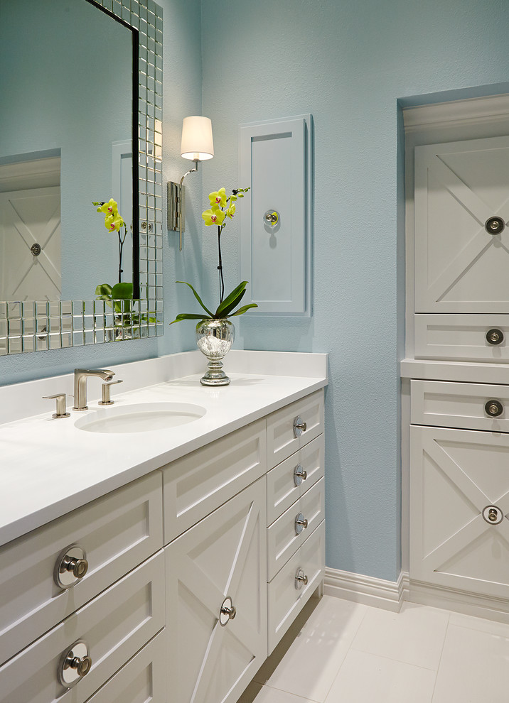 Design ideas for a small beach style 3/4 bathroom in Dallas with raised-panel cabinets, white cabinets, a one-piece toilet, white tile, stone slab, blue walls, marble floors and marble benchtops.