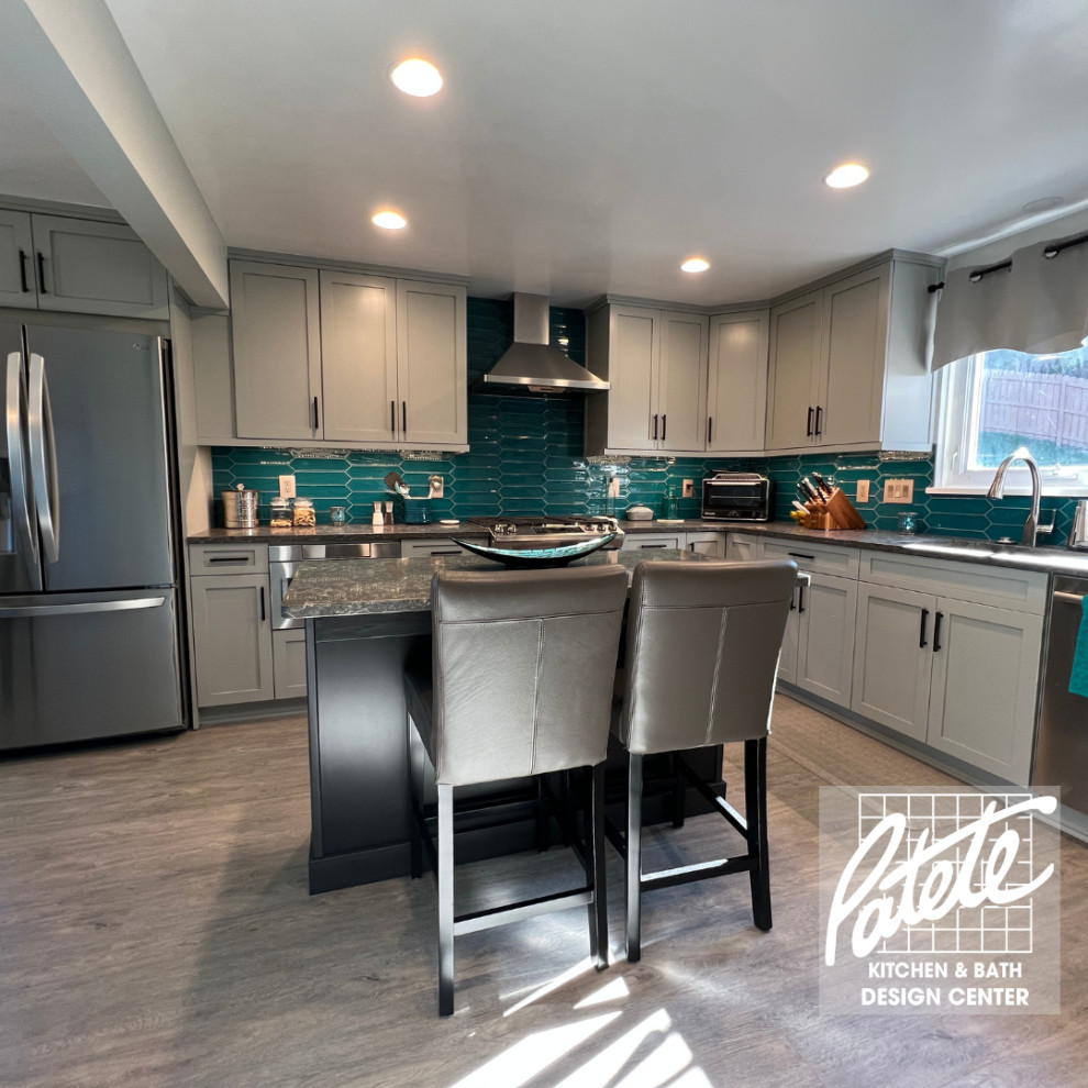 Eat-in kitchen - mid-sized transitional l-shaped eat-in kitchen idea with shaker cabinets, blue cabinets, granite countertops, blue backsplash, glass tile backsplash, stainless steel appliances, an island and multicolored countertops