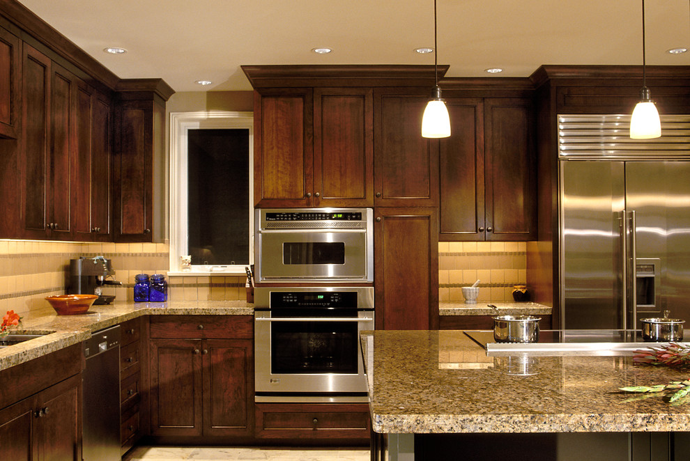 Eat-in kitchen - large transitional l-shaped marble floor eat-in kitchen idea in Seattle with an undermount sink, recessed-panel cabinets, dark wood cabinets, granite countertops, yellow backsplash, ceramic backsplash, stainless steel appliances and an island