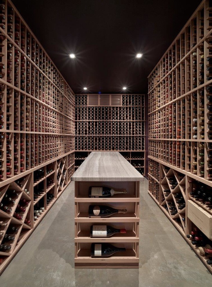 Inspiration for a transitional wine cellar in San Francisco with concrete floors, storage racks and grey floor.