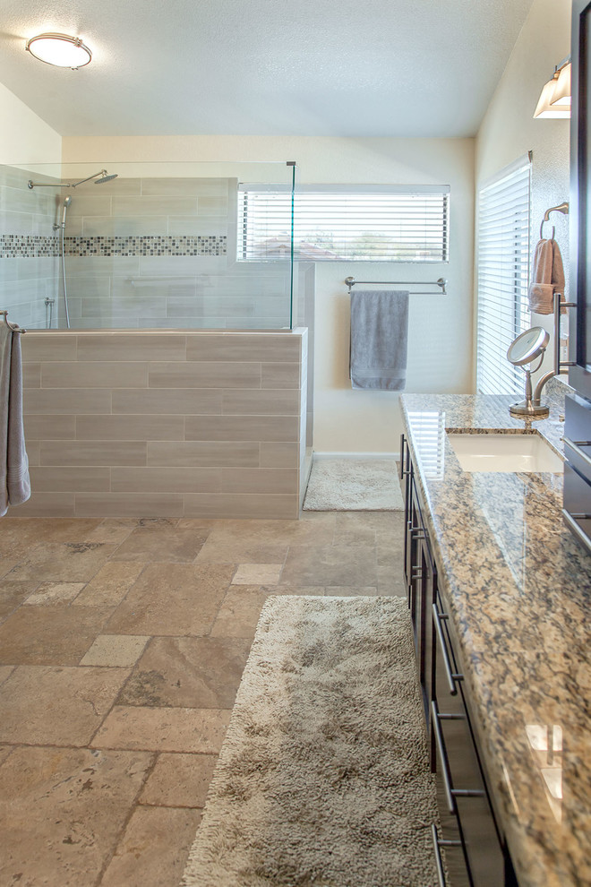 Large transitional master brown tile and porcelain tile ceramic tile walk-in shower photo in Phoenix with recessed-panel cabinets, dark wood cabinets, a two-piece toilet, beige walls, an undermount sink and granite countertops