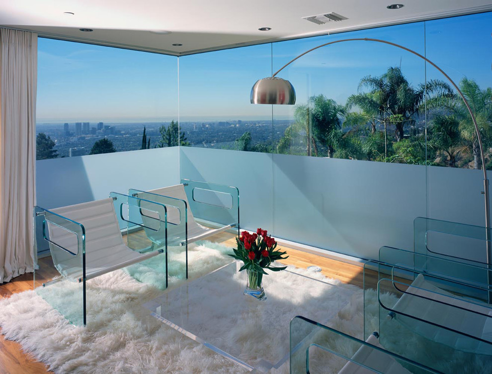 This is an example of a mid-sized contemporary enclosed family room in Los Angeles with light hardwood floors.