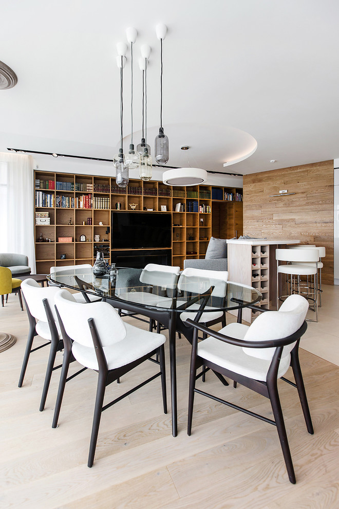 Photo of a large contemporary open plan dining in Moscow with light hardwood floors.