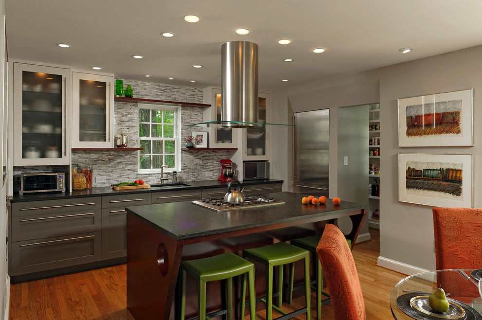 Mid-sized contemporary galley eat-in kitchen in DC Metro with an undermount sink, multi-coloured splashback, stainless steel appliances, medium hardwood floors, with island, shaker cabinets, grey cabinets, granite benchtops and stone tile splashback.