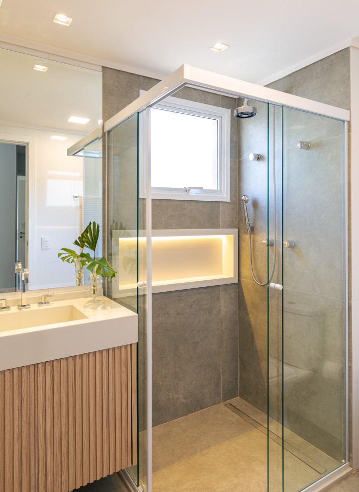 Immagine di una stanza da bagno minimal con WC monopezzo, pareti bianche, lavabo integrato, top in marmo, pavimento grigio e top bianco