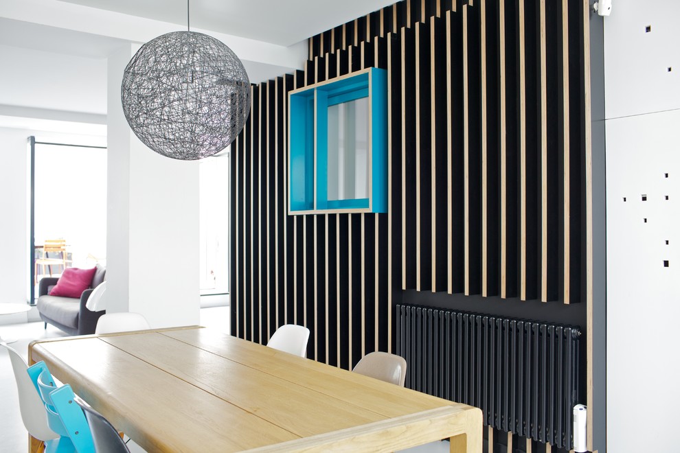 Design ideas for a mid-sized contemporary open plan dining in Paris with black walls.