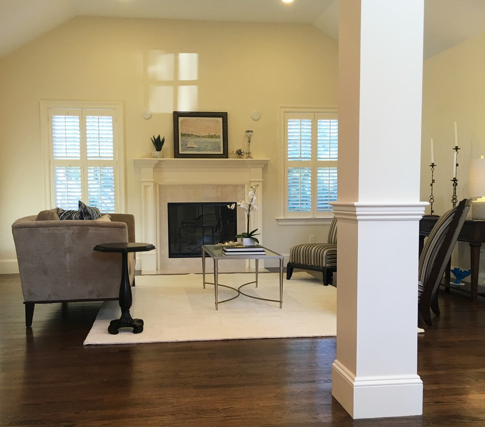 This is an example of a mid-sized transitional formal enclosed living room in Boston with white walls, medium hardwood floors, a standard fireplace, a tile fireplace surround and no tv.