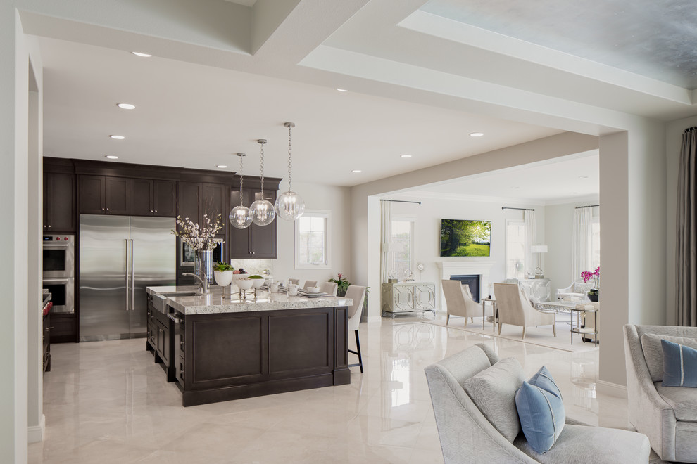 Eat-in kitchen - transitional beige floor eat-in kitchen idea in Orange County with dark wood cabinets, stainless steel appliances and an island