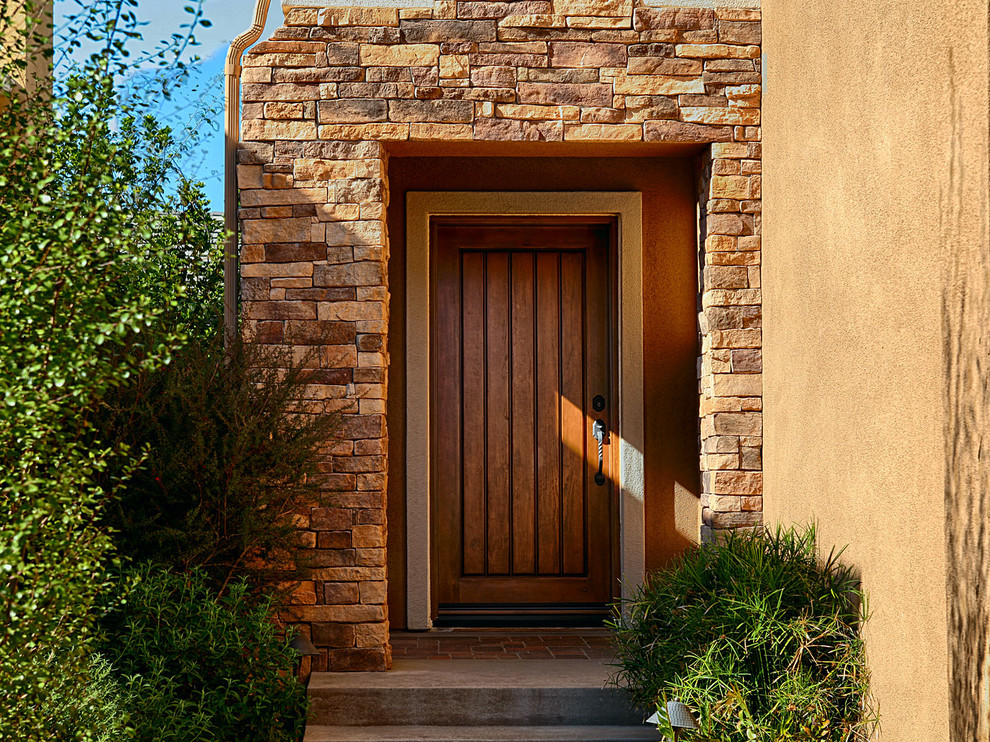 Front door - large rustic front door idea in Orange County with brown walls and a light wood front door