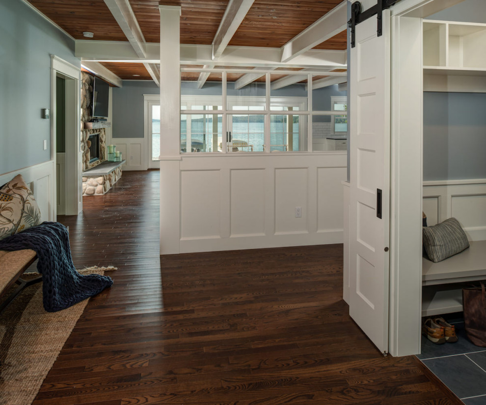 Inspiration for a large beach style foyer in Other with blue walls, dark hardwood floors, a double front door, a red front door and brown floor.