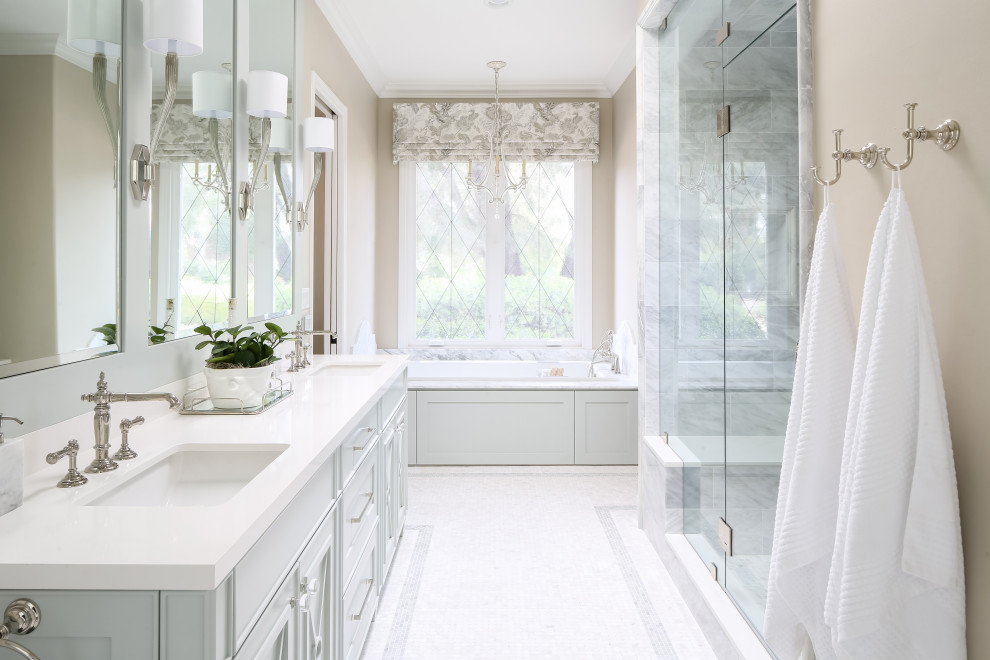 Design ideas for a transitional master bathroom in San Diego with an alcove tub, an alcove shower, marble, beige walls, marble floors, engineered quartz benchtops, a hinged shower door, grey cabinets, an undermount sink, white floor and white benchtops.