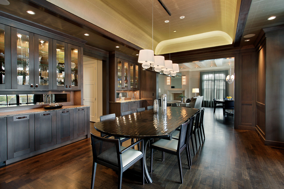 This is an example of a large transitional separate dining room in Chicago with dark hardwood floors and brown walls.