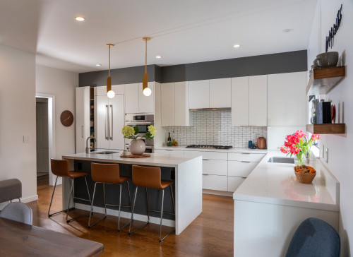Modern white L-Shaped Kitchen Cabinets with island and bar stools in a contemporary open-concept design