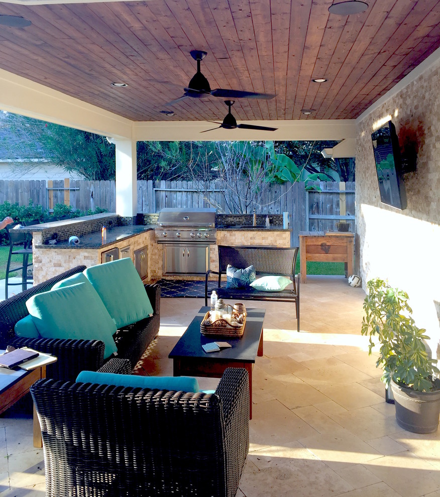 Design ideas for a transitional backyard verandah in Houston with natural stone pavers and a roof extension.