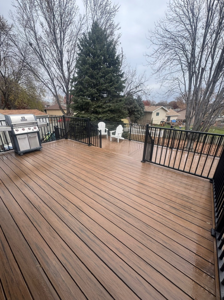 Deck - large metal railing deck idea in Omaha with no cover