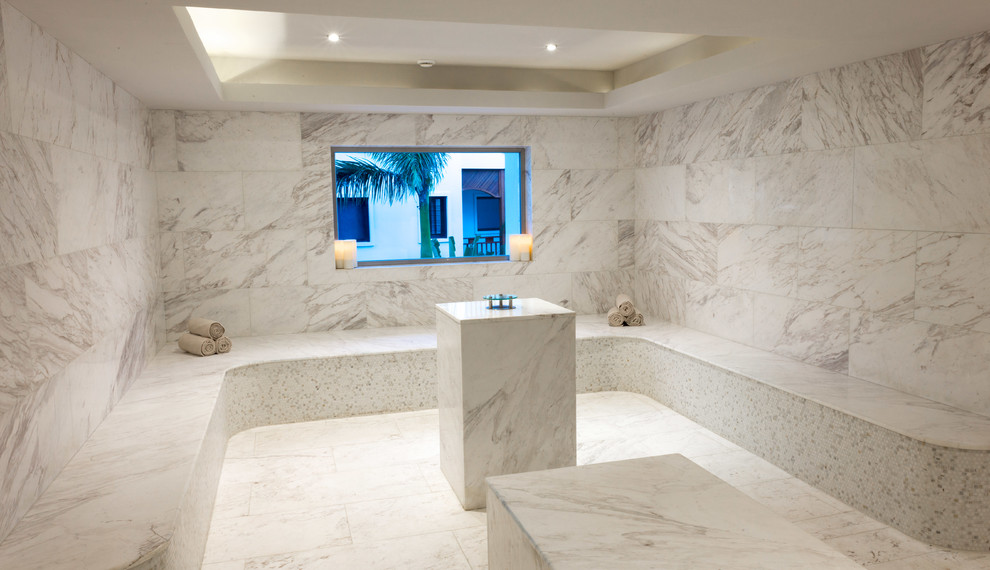 Inspiration for a mediterranean bathroom in Austin with white tile, stone slab and marble benchtops.