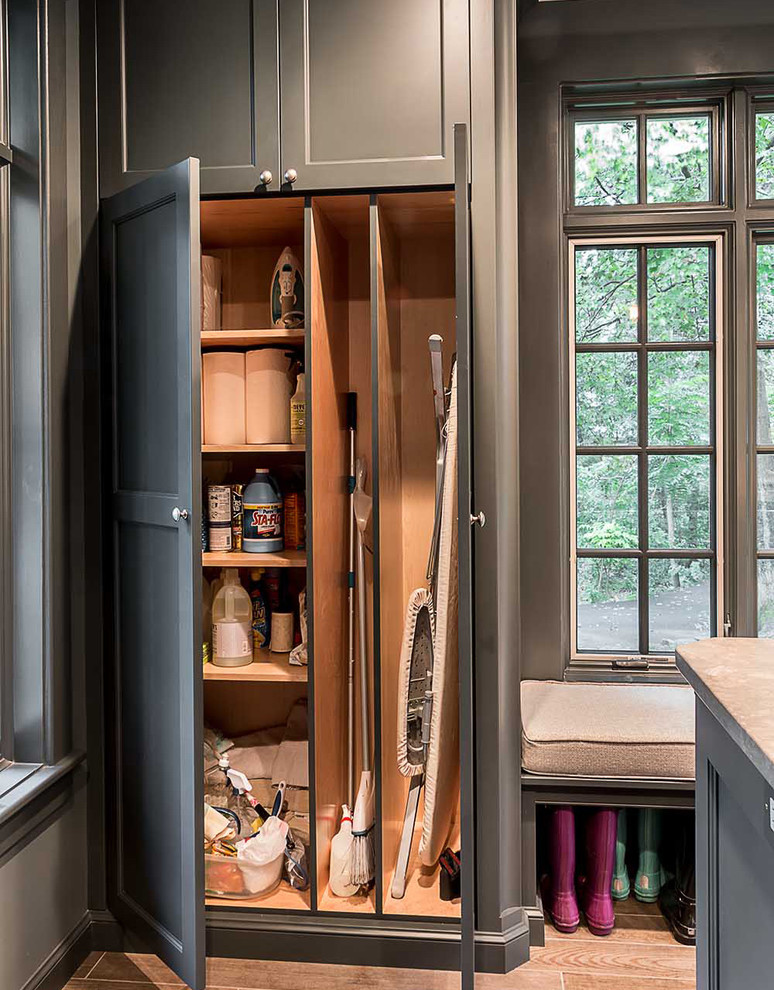 Utility room - large scandinavian medium tone wood floor utility room idea in Chicago with gray cabinets, quartz countertops, gray walls, a side-by-side washer/dryer and recessed-panel cabinets