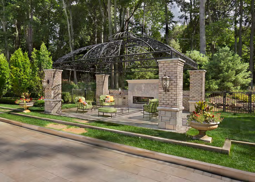 Large modern backyard partial sun garden in Detroit with a fire feature and natural stone pavers.