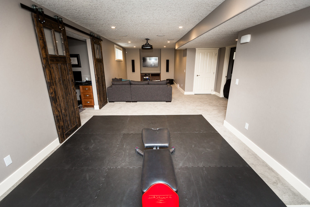 Small traditional open concept home theatre in Calgary with grey walls, carpet and a projector screen.