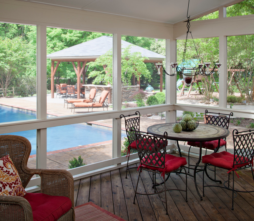 Inspiration for an expansive traditional backyard screened-in verandah in Charlotte with a roof extension and decking.