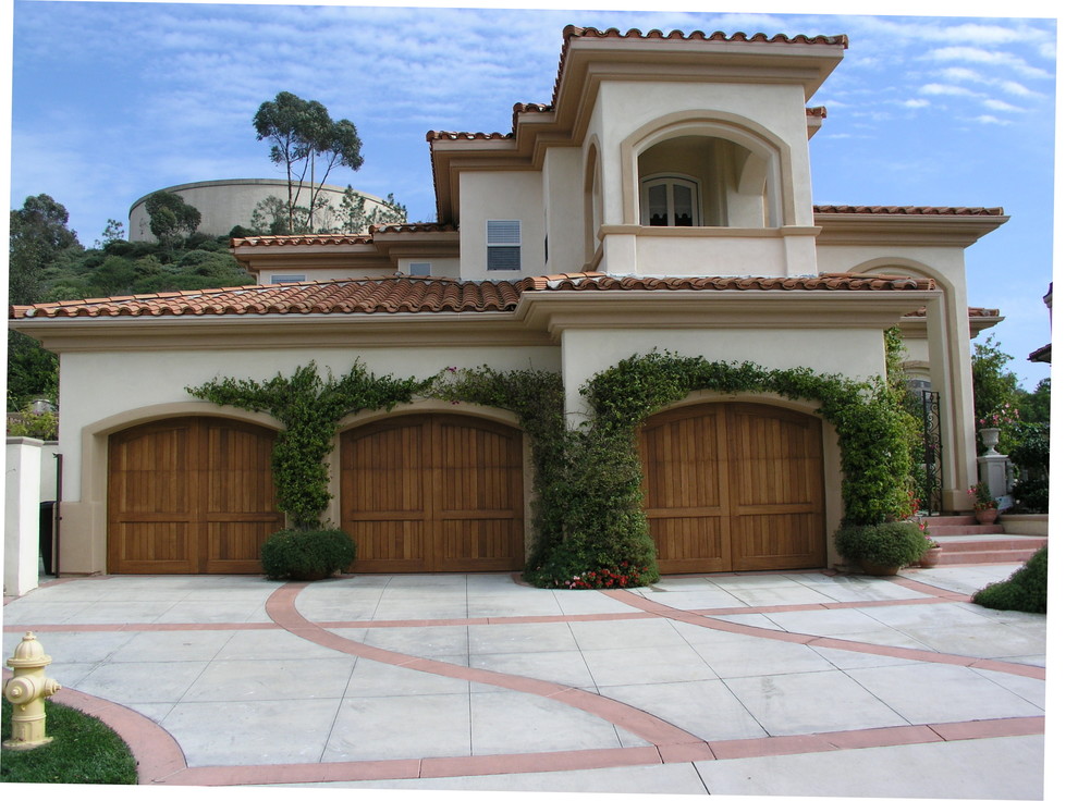 Design ideas for a large mediterranean attached three-car garage in Los Angeles.
