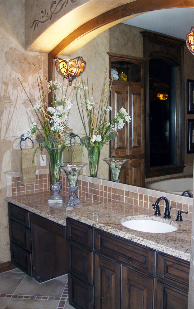 Mid-sized traditional master bathroom in Wichita with raised-panel cabinets, dark wood cabinets, terra-cotta tile, beige walls, an undermount sink, granite benchtops, ceramic floors and beige floor.