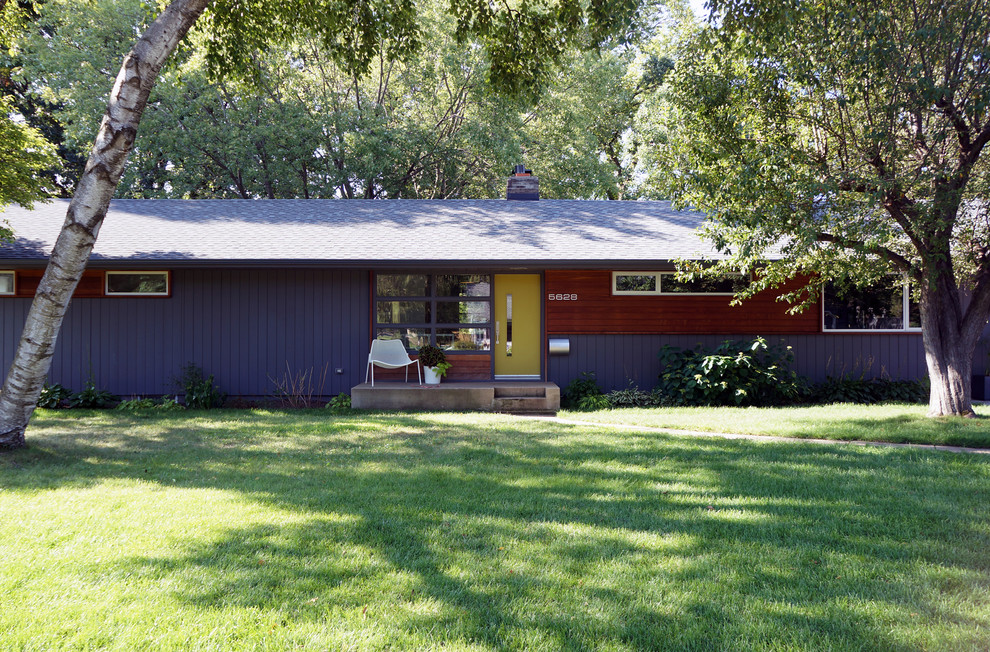Design ideas for a mid-sized midcentury one-storey purple exterior in Minneapolis.