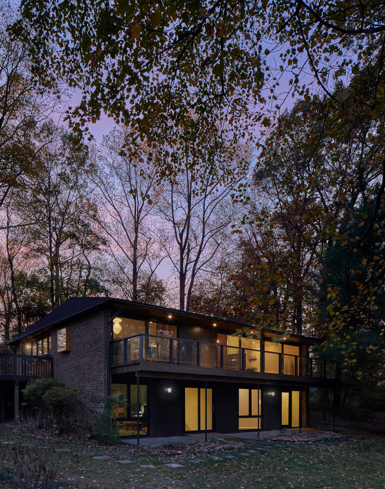 Design ideas for a midcentury two-storey brick brown house exterior in DC Metro with a hip roof and a shingle roof.