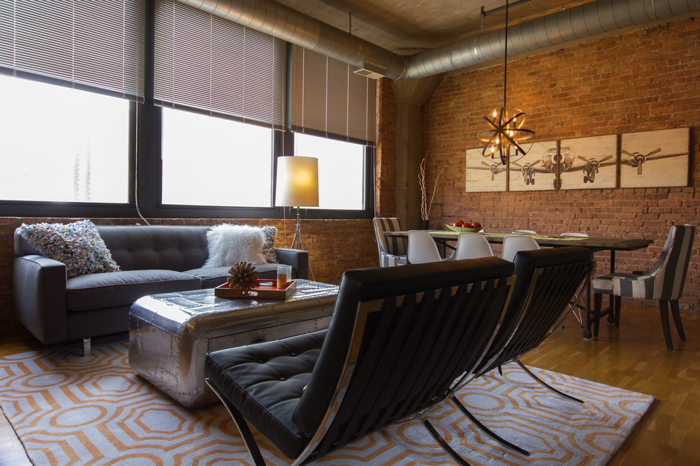 Mid-sized industrial formal open concept living room in Chicago with red walls, light hardwood floors, no fireplace and a wall-mounted tv.