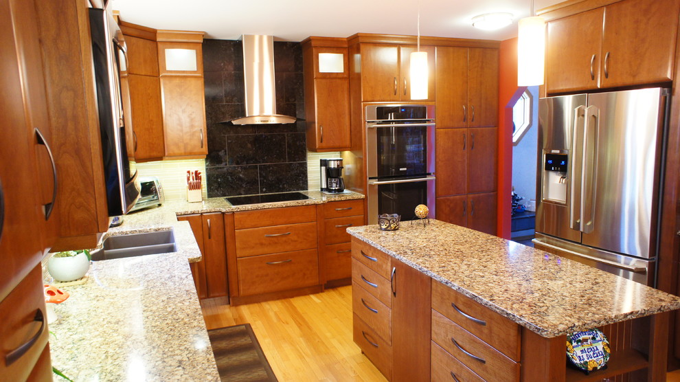 Inspiration for a large transitional u-shaped medium tone wood floor and beige floor open concept kitchen remodel with an undermount sink, flat-panel cabinets, dark wood cabinets, granite countertops, gray backsplash, subway tile backsplash, stainless steel appliances and an island