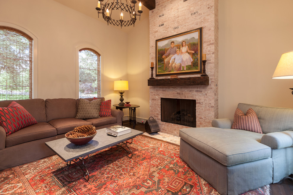 Expansive traditional enclosed family room in Houston with white walls, dark hardwood floors, a standard fireplace, a brick fireplace surround, no tv and brown floor.