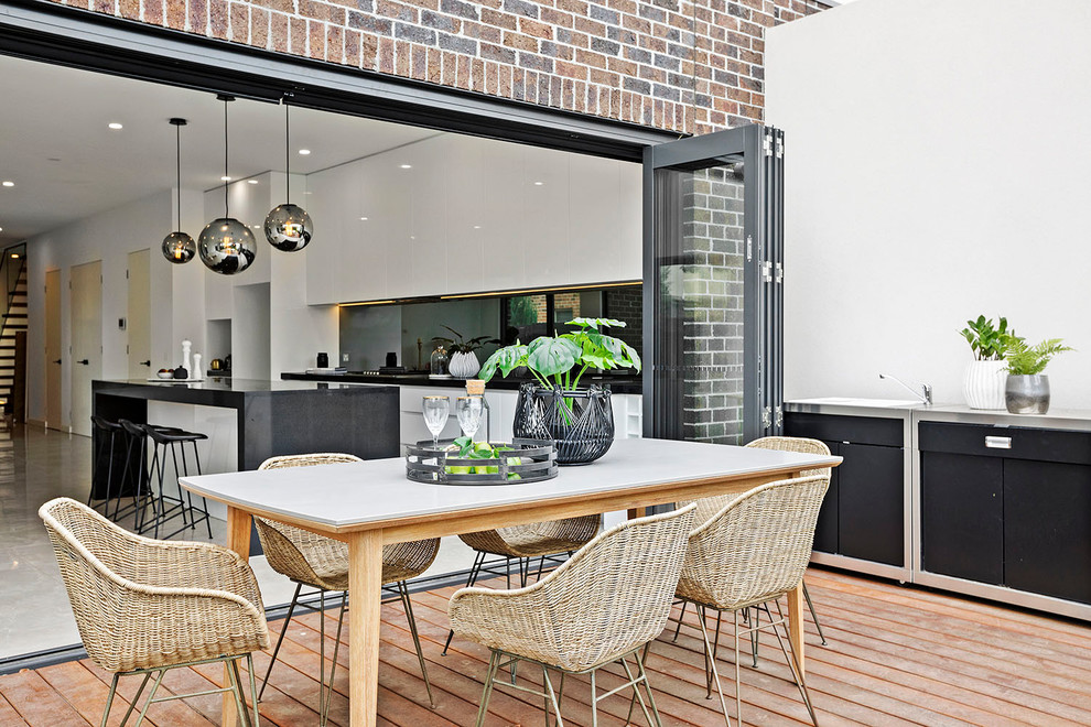 Photo of a transitional backyard deck in Melbourne with an outdoor kitchen and no cover.