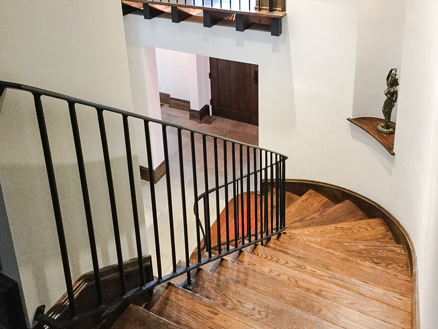 This is an example of a mid-sized industrial wood curved staircase in Atlanta with wood risers.