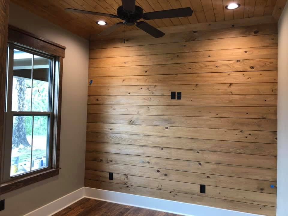 Example of a mid-sized mountain style guest medium tone wood floor and brown floor bedroom design with brown walls and no fireplace