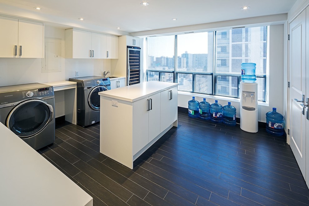 This is an example of a transitional laundry room in Toronto with a drop-in sink, flat-panel cabinets, white cabinets, white walls, a side-by-side washer and dryer and white benchtop.