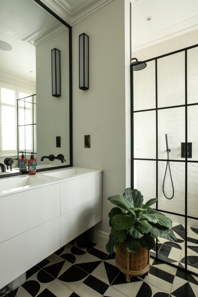 Design ideas for a small contemporary half tiled bathroom in London with flat-panel cabinets, white cabinets, white tiles, ceramic tiles, multi-coloured floors, double sinks, a floating vanity unit and a corner shower.
