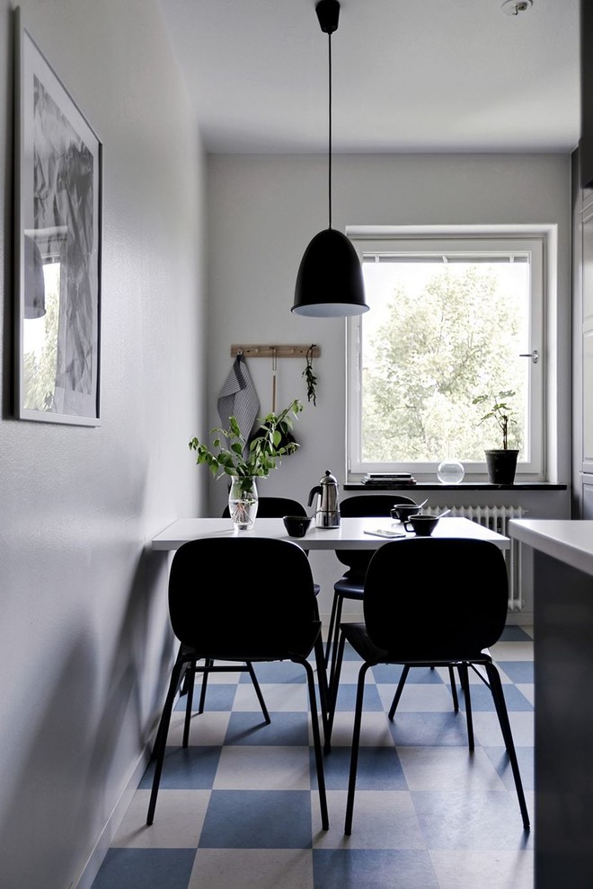 This is an example of a mid-sized scandinavian dining room in Stockholm with multi-coloured floor and linoleum floors.