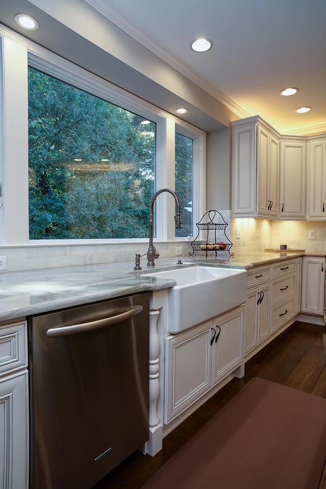 Eat-in kitchen - transitional u-shaped dark wood floor eat-in kitchen idea in Cedar Rapids with a farmhouse sink, flat-panel cabinets, white cabinets, marble countertops, stainless steel appliances and an island